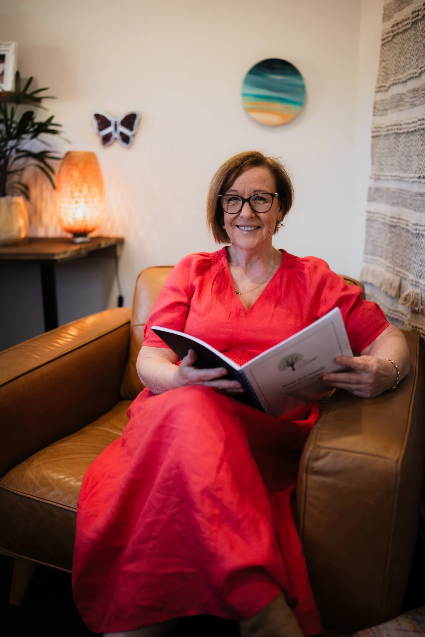 Portrait of Clinical Psychologist Lisa Arnold, a warm clinical psychologist in a sage green sweater
